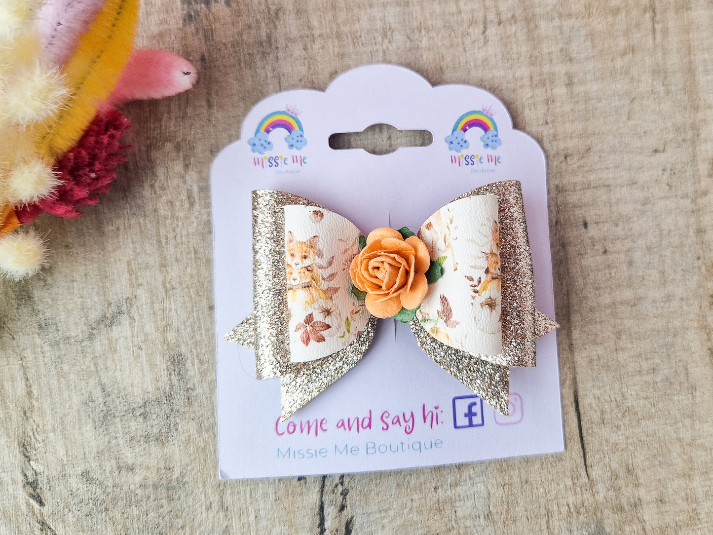 Autumn Hair bow with a Woodland Design and embellished with an orange Flower.
