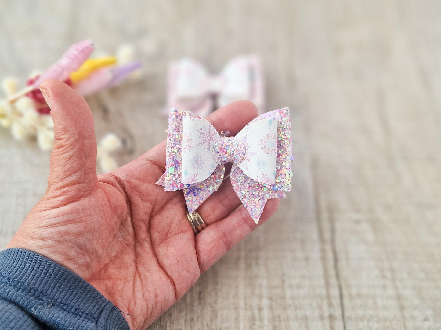 Pink Christmas Glitter Hair Bow in a Snowflake Design For Toddler or Girl.