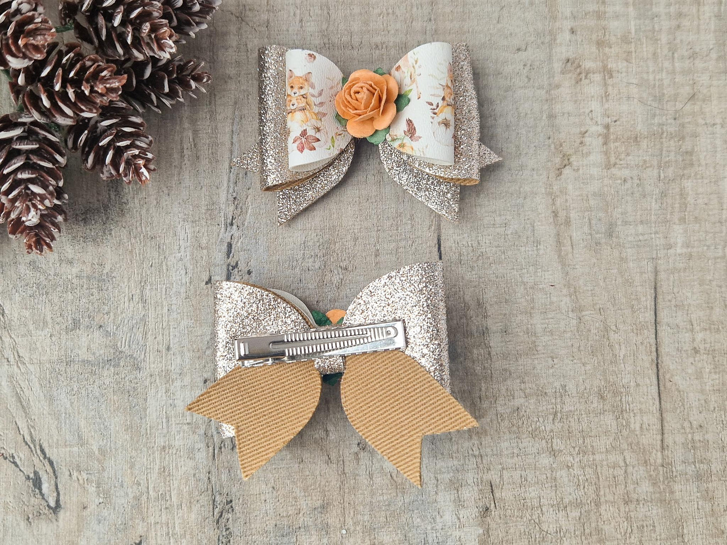 Autumn Hair bow with a Woodland Design and embellished with an orange Flower.