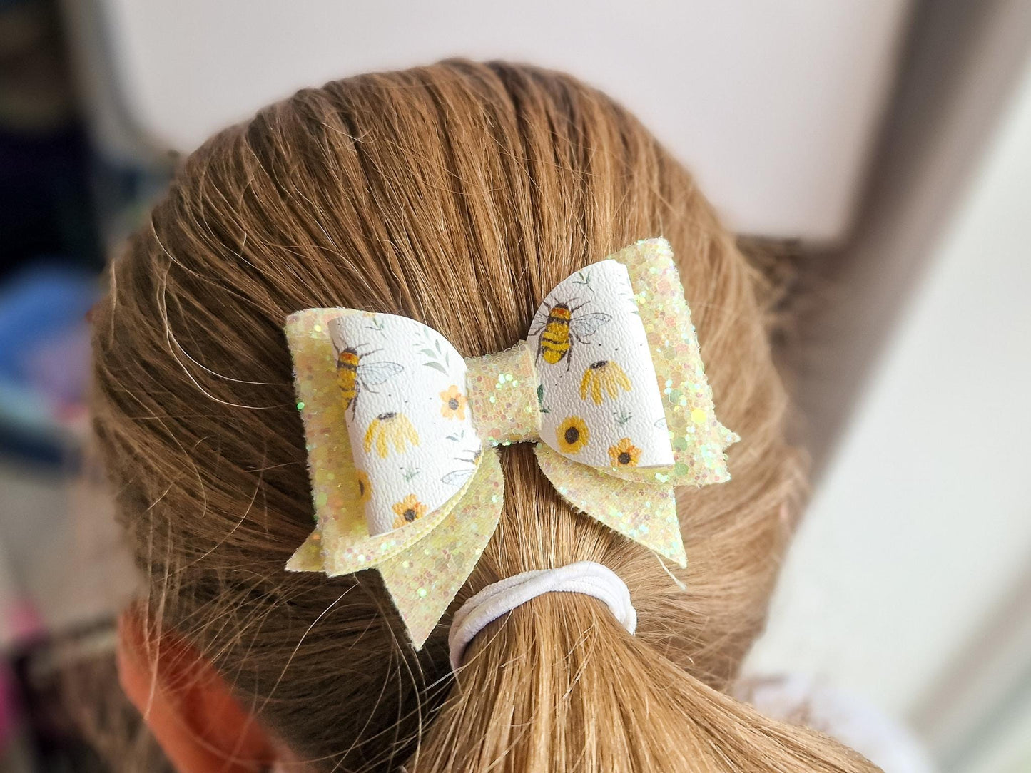 Bee Hair bow with Yellow Glitter on a Hair clip. Small bow suitable for toddler upwards.