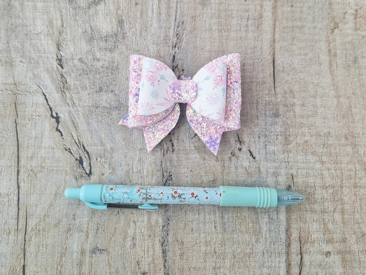 Pink Christmas Glitter Hair Bow in a Snowflake Design For Toddler or Girl.