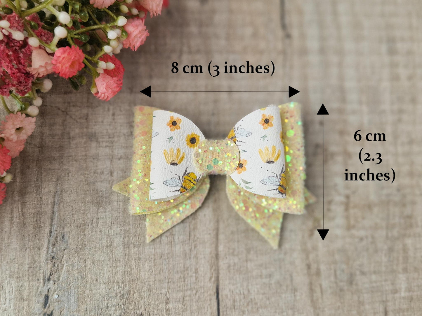 Bee Hair bow with Yellow Glitter on a Hair clip. Small bow suitable for toddler upwards.