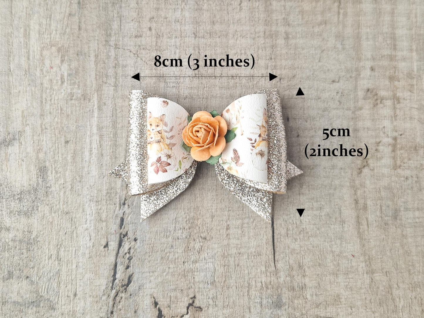 Autumn Hair bow with a Woodland Design and embellished with an orange Flower.