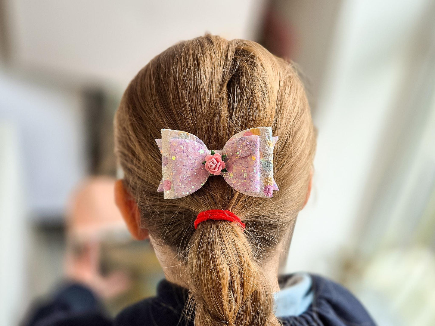 Glitter Hair bow, in pink Pastel glitter colours with a heart and flower Embellishment.