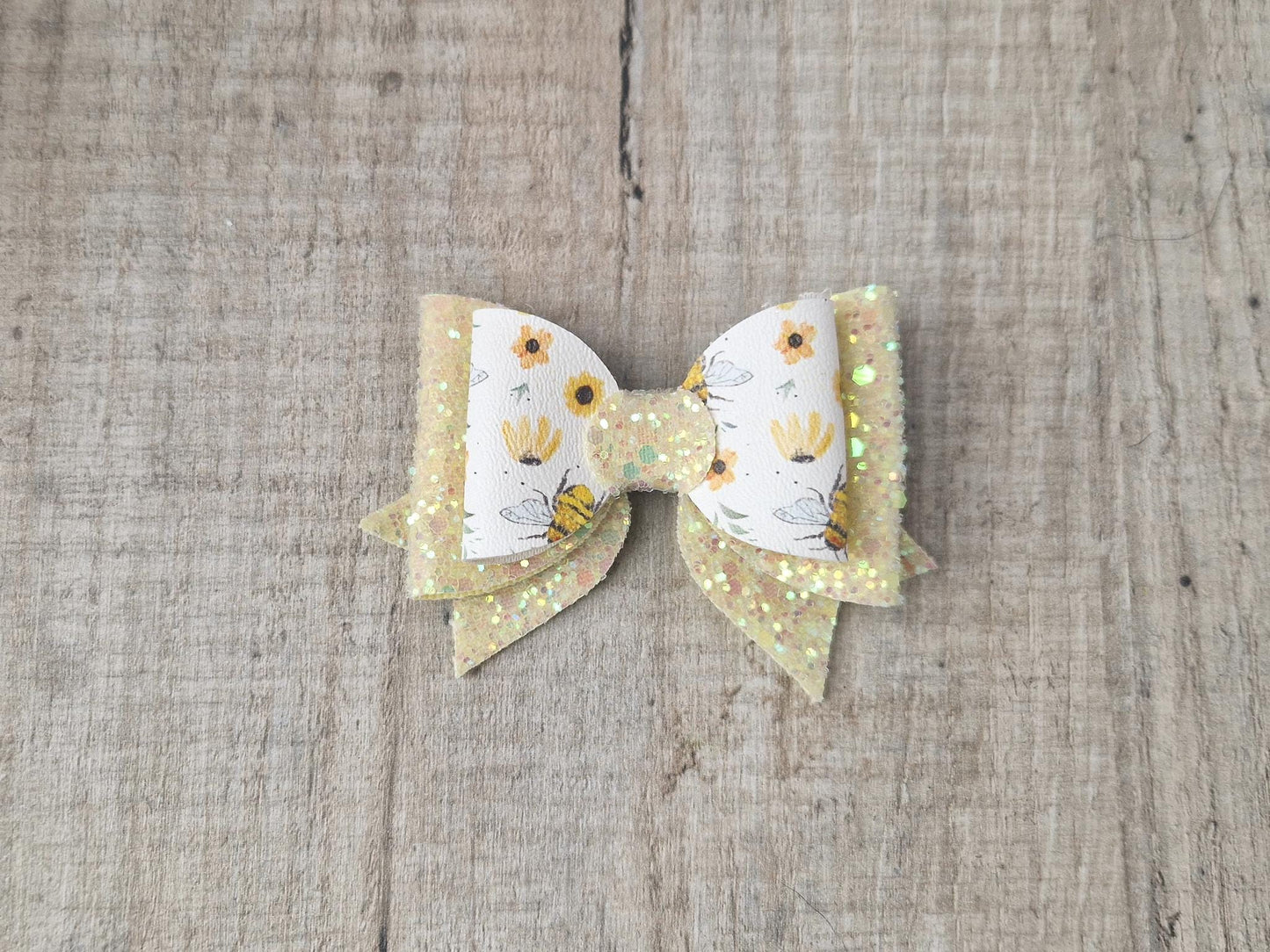 Bee Hair bow with Yellow Glitter on a Hair clip. Small bow suitable for toddler upwards.