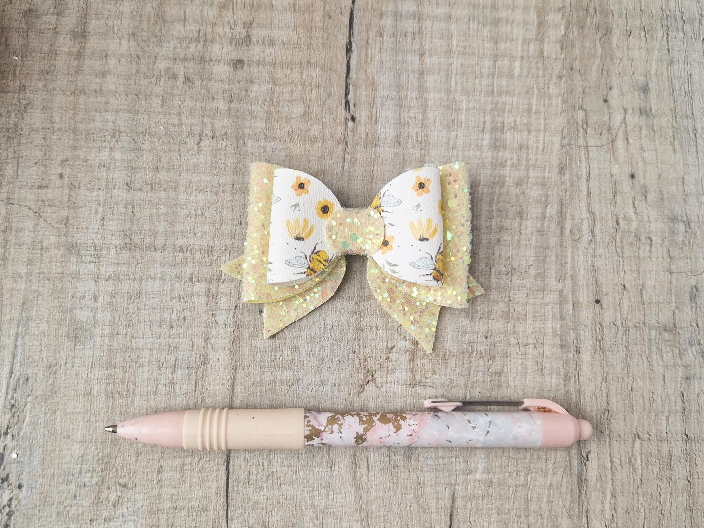 Bee Hair bow with Yellow Glitter on a Hair clip. Small bow suitable for toddler upwards.