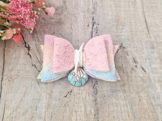 Large Mermaid Hair bow with a sea shell embellishment.