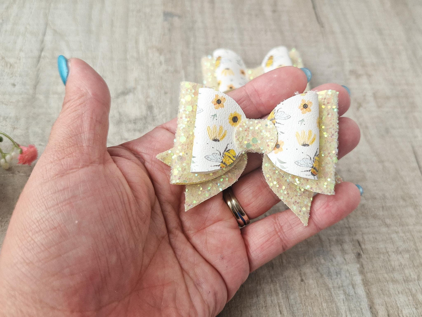 Bee Hair bow with Yellow Glitter on a Hair clip. Small bow suitable for toddler upwards.
