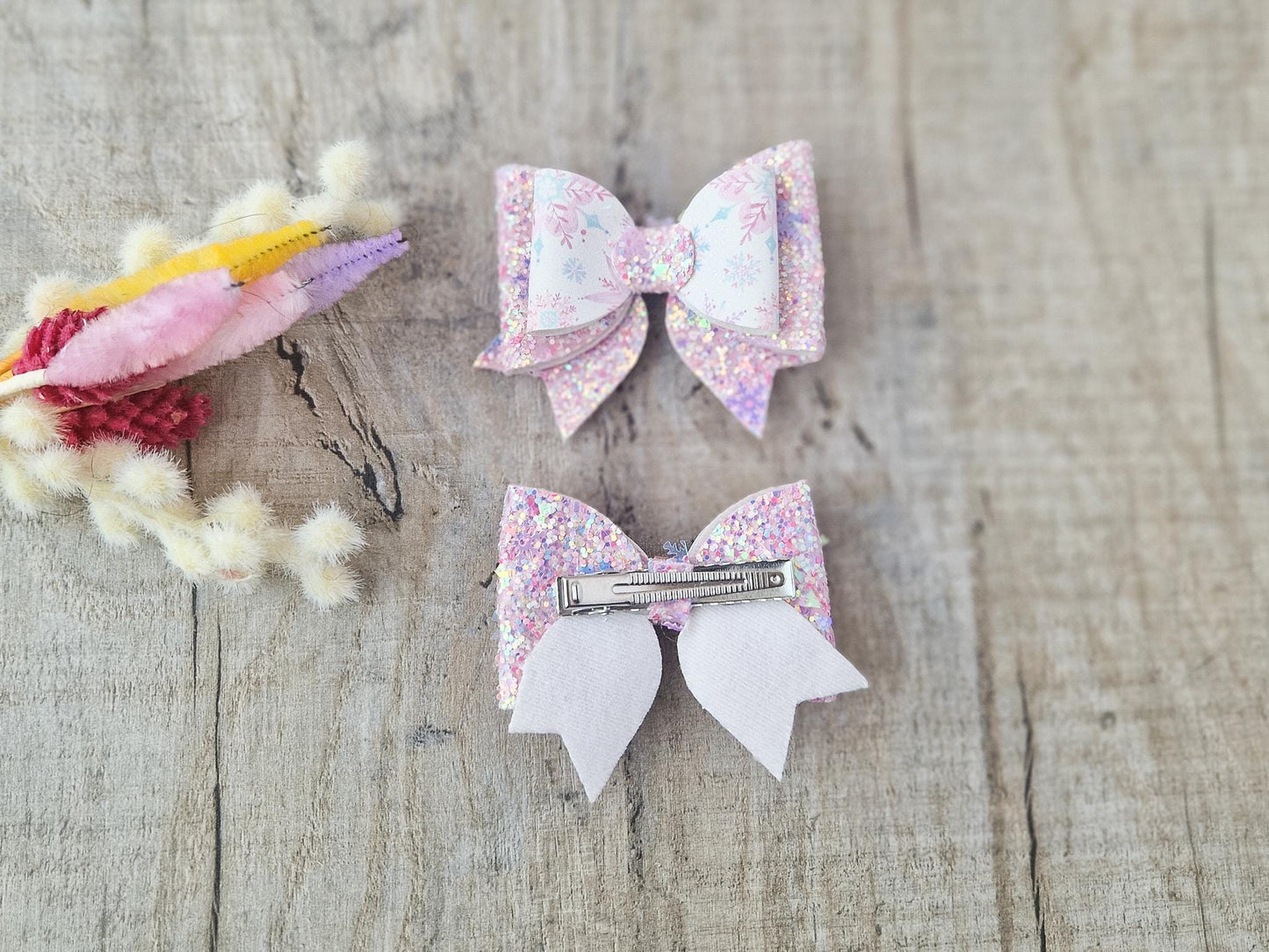 Pink Christmas Glitter Hair Bow in a Snowflake Design For Toddler or Girl.