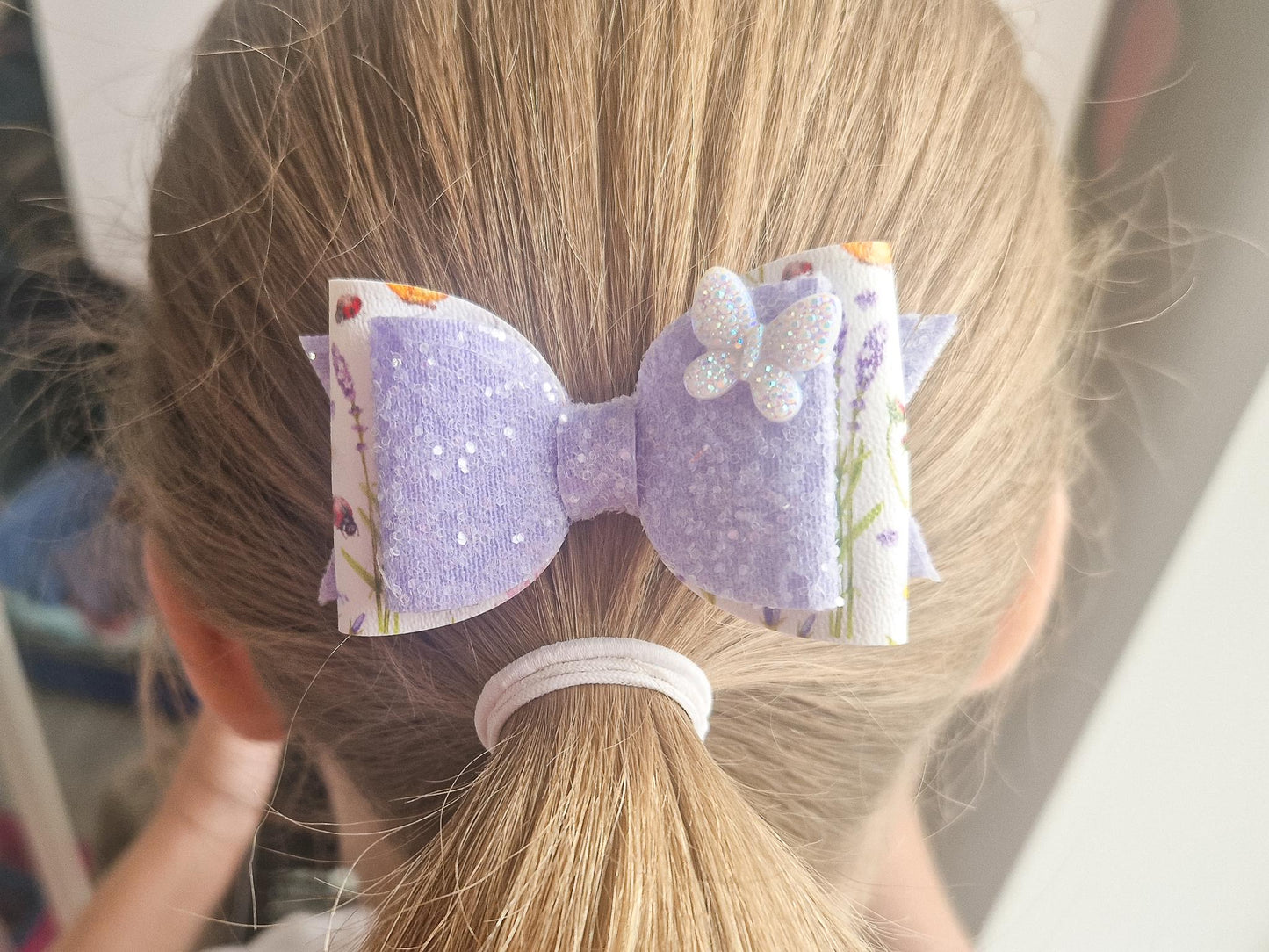 Purple Glitter Hair Bow with Butterfly embellishment and floral design.