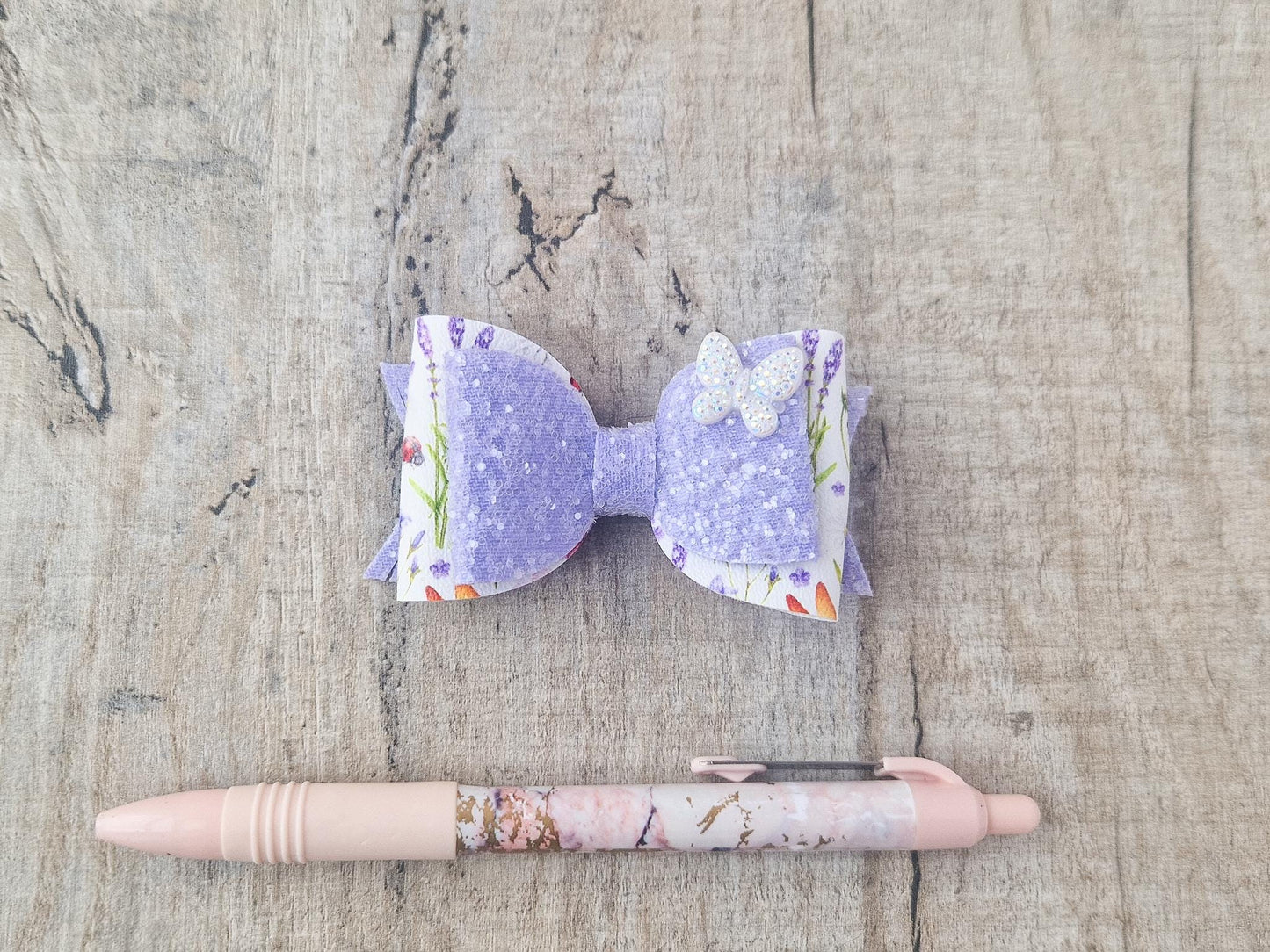 Purple Glitter Hair Bow with Butterfly embellishment and floral design.