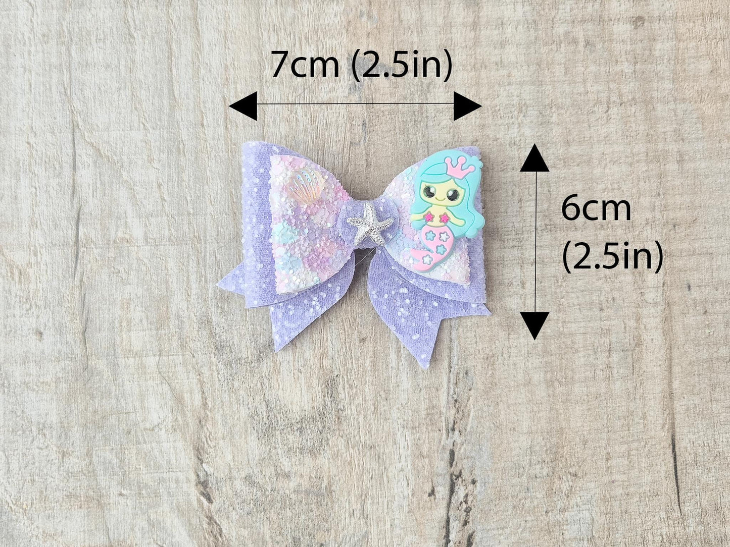 Blue Mermaid Glitter Hair bow embellished with a Mermaid, star fish and sea shell.