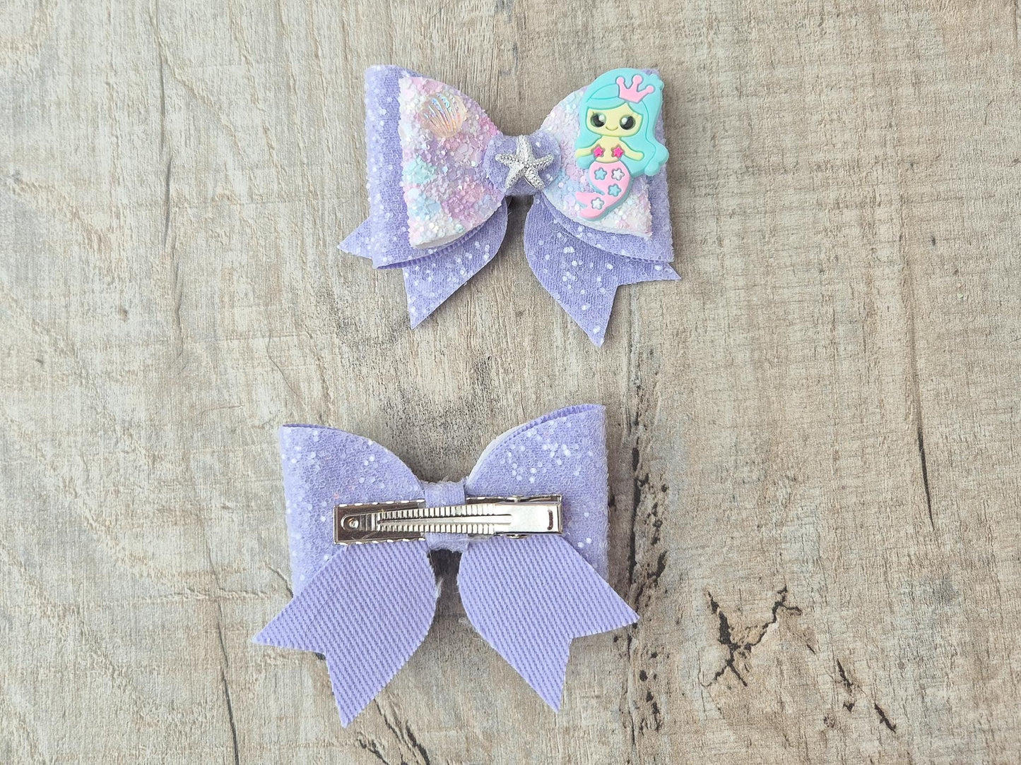 Blue Mermaid Glitter Hair bow embellished with a Mermaid, star fish and sea shell.