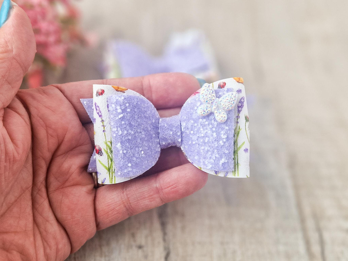 Purple Glitter Hair Bow with Butterfly embellishment and floral design.