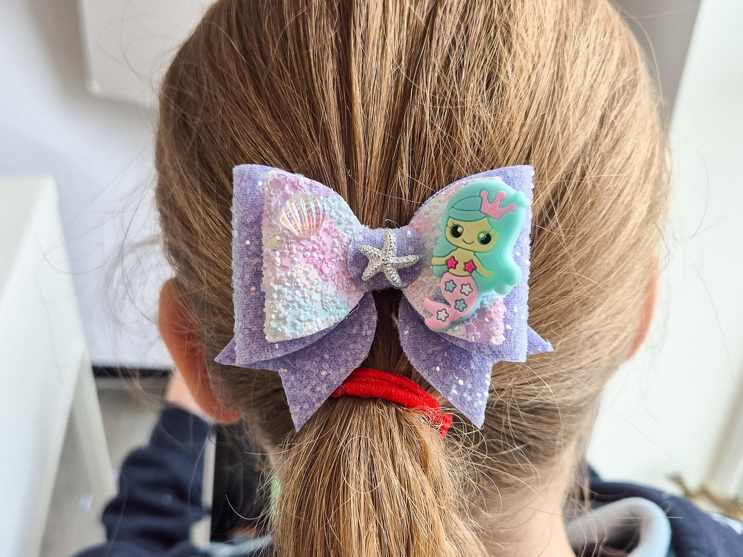 Blue Mermaid Glitter Hair bow embellished with a Mermaid, star fish and sea shell.