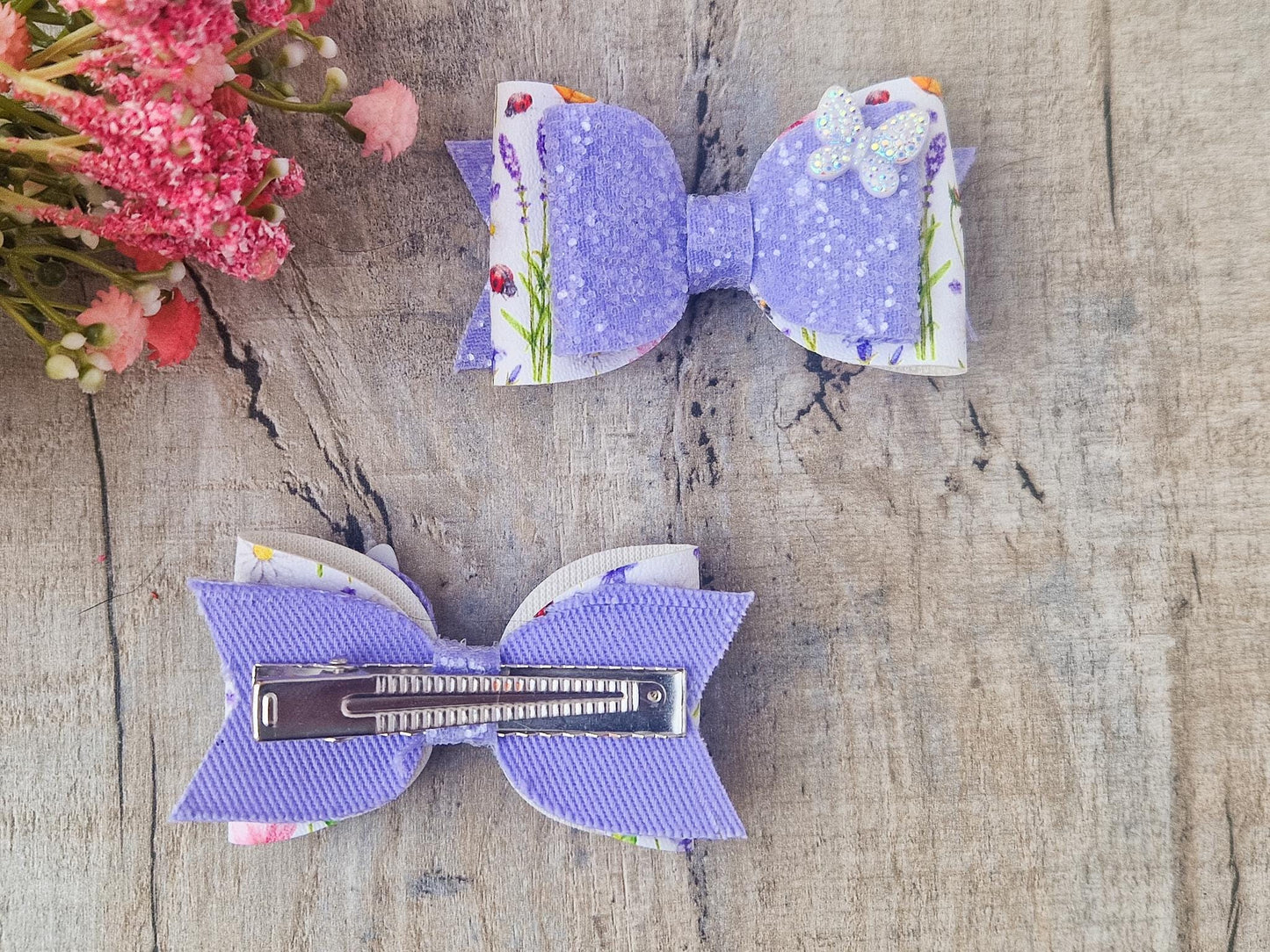 Purple Glitter Hair Bow with Butterfly embellishment and floral design.
