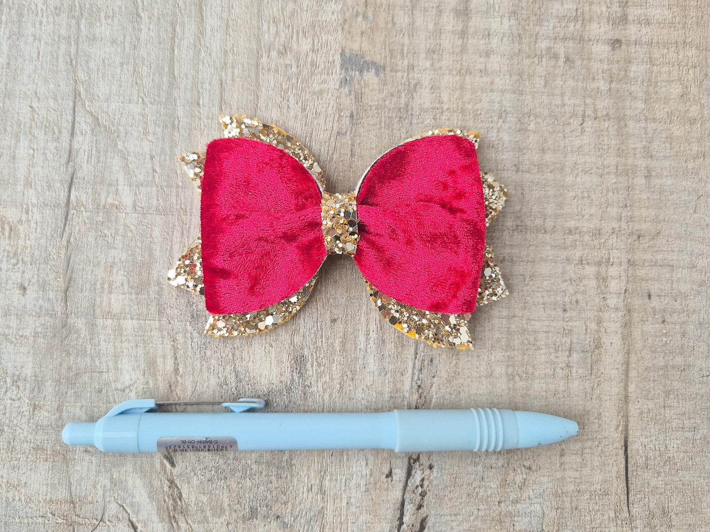 Red Christmas Hair bow for Girls made with Red velvet and gold glitter, the perfect accessory for older girls upwards