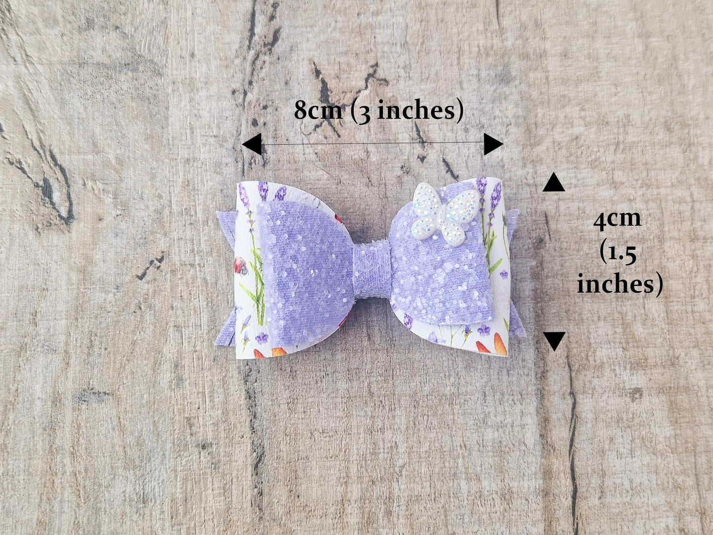 Purple Glitter Hair Bow with Butterfly embellishment and floral design.