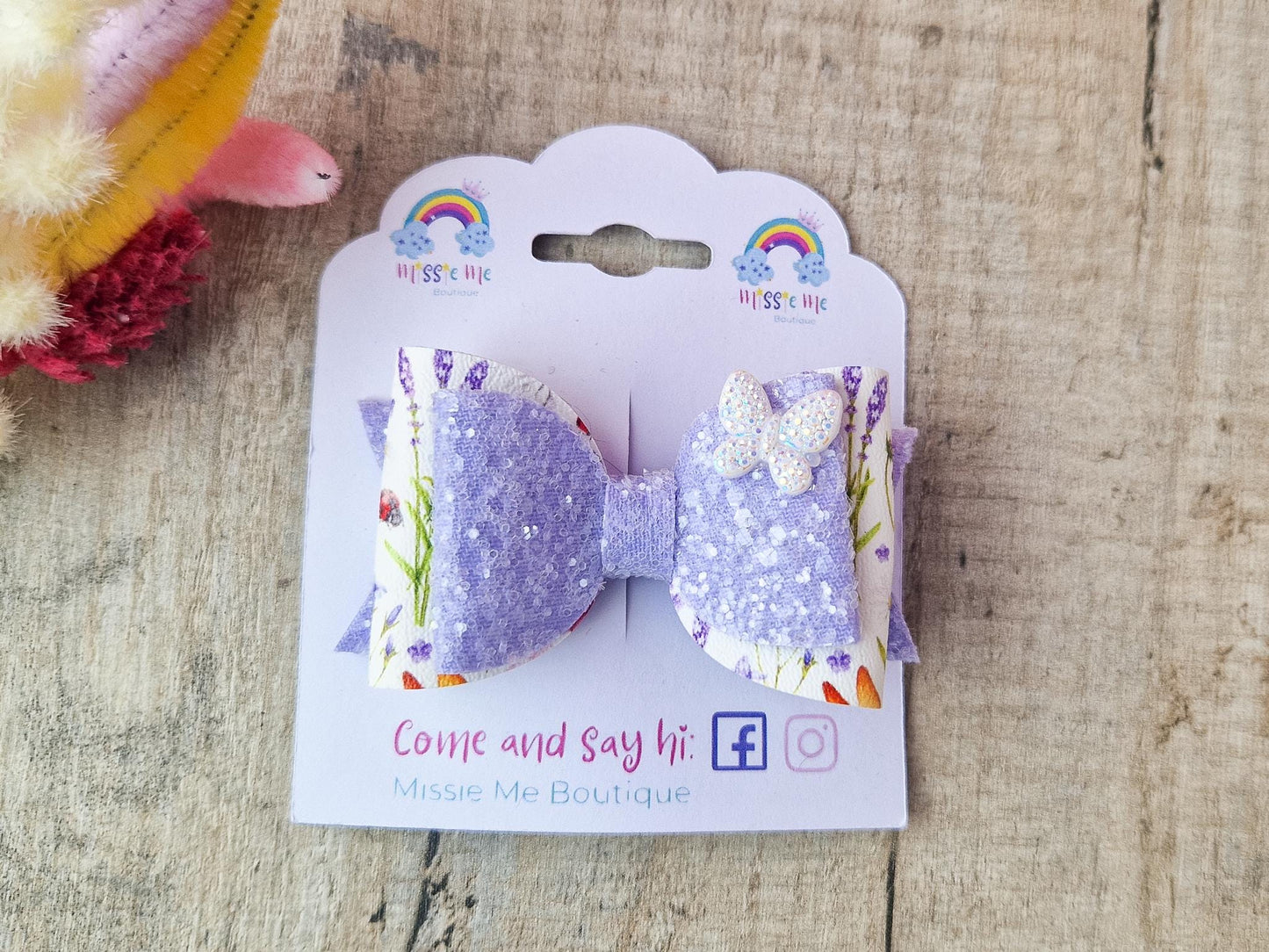Purple Glitter Hair Bow with Butterfly embellishment and floral design.