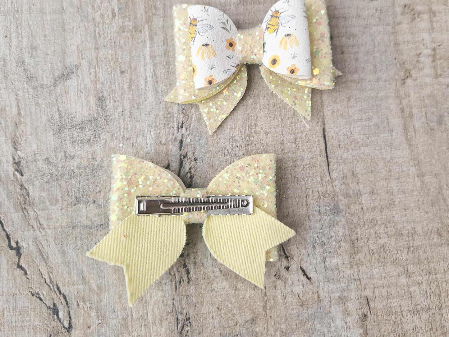 Bee Hair bow with Yellow Glitter on a Hair clip. Small bow suitable for toddler upwards.