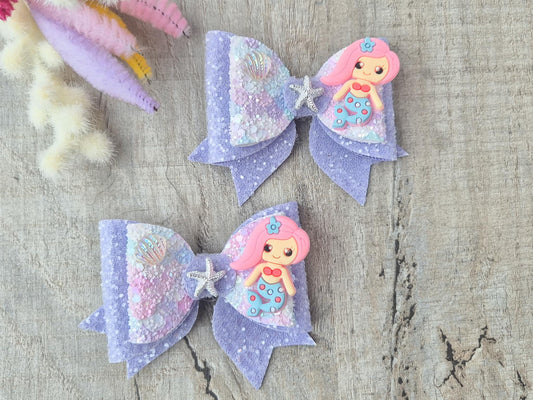 Pink Mermaid Glitter Hair bow embellished with a Mermaid, star fish and sea shell.