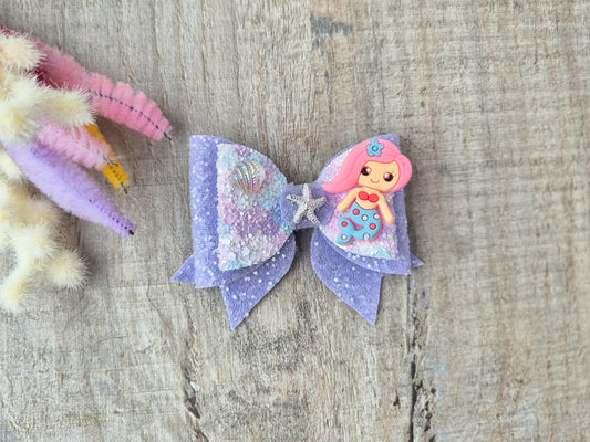 Pink Mermaid Glitter Hair bow embellished with a Mermaid, star fish and sea shell.