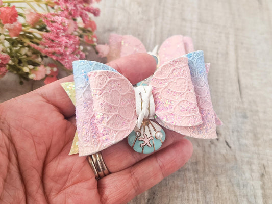 Large Mermaid Hair bow with a sea shell embellishment.