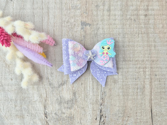 Blue Mermaid Glitter Hair bow embellished with a Mermaid, star fish and sea shell.