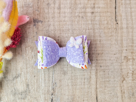 Purple Glitter Hair Bow with Butterfly embellishment and floral design.