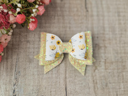 Bee Hair bow with Yellow Glitter on a Hair clip. Small bow suitable for toddler upwards.